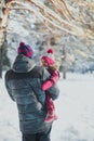 Winter walk with a child: dad and daughter walk in the winter forest 1 Royalty Free Stock Photo