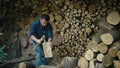 Winter warmth prep: guy laboring to gather firewood for farmhouse fireplace