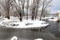 Winter water landscape. Trees covered with snow and frost stand on a picturesque river, pond, lake, forest or park on cold, frosty Royalty Free Stock Photo