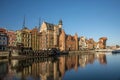 Winter in harbor with waterfront of Old Town in Gdansk, Poland, with sailship and sunlight Royalty Free Stock Photo