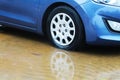 Winter weather in Israel: rain, puddles, floods and flooding. Car wheel in a puddle of rainwater, raindrops and water circles Royalty Free Stock Photo