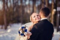 Winter wedding. Beautiful young couple in the woods.