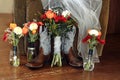 Winter wedding bouquet - red chrysanthemum, orange tulips, blue thistle and fern leaves arrangement, cowboy boots