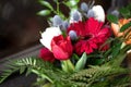 Winter wedding bouquet - red chrysanthemum, orange tulips, blue thistle and fern leaves arrangement