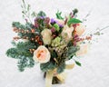 Winter wedding bouquet of roses and tree branches in the snow Royalty Free Stock Photo