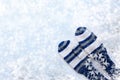 Winter white background with white and blue striped mittens, twigs, one big snowflake and copy space. Royalty Free Stock Photo