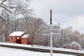 Winter white snow covered road sign with directions on slope Royalty Free Stock Photo