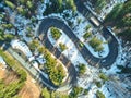 Winter winding road in the mountains with cars passing through Royalty Free Stock Photo