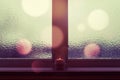 Winter window with burning candle and bokeh lights Royalty Free Stock Photo