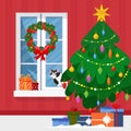 Winter window with view, a present and a cat on the sill. Christmas tree and wreath. Cozy home. Merry Christmas and Royalty Free Stock Photo