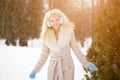 Winter woman on background of winter landscape? sun. Fashion girl in forest wonderland. Winter sunset scene. Model in sunlight, b Royalty Free Stock Photo