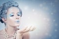 Winter Woman Fashion Model Blowing Snow at Night Royalty Free Stock Photo
