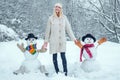 Winter woman. Funny Girl Love winter. Winter portrait of young woman in the winter snowy scenery. Cute girl making Royalty Free Stock Photo