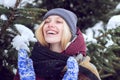 Winter woman with gift. Outdoor close up portrait of beautiful smiling blonde woman with red nose walking at winter park Royalty Free Stock Photo