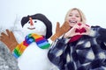 Winter woman. Happy smiling girl make snowman on sunny winter day. Winter emotion. Royalty Free Stock Photo