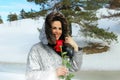 Winter woman holding red rose