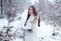 Winter woman. Laughing Girl Outdoors. Model wearing stylish sweater and gloves. Portrait of a young woman in snow trying Royalty Free Stock Photo