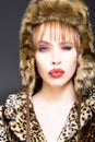 Winter Woman in Luxury Fur Coat and Hat. Beauty Fashion Model Girl in Leopard Fur Coat. Perfect Makeup. Beautiful Luxury Royalty Free Stock Photo