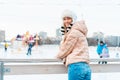 Winter woman portrait. Beautiful middle age caucasian female standing outdoor dressed funny fluffy hat looking camera smile Royalty Free Stock Photo