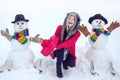 Winter woman. Winter portrait. Winter woman clothes. Making snowman and winter fun for people.