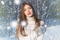 Winter woman in snow looking up at copy space outside on snowing cold winter day. Portrait multiethnic Caucasian Asian female mode