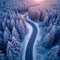 Winter wonderland aerial view of curvy road in snow covered forest