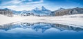 Winter wonderland in the Alps reflecting in crystal clear mountain lake Royalty Free Stock Photo