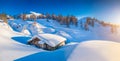 Winter wonderland in the Alps with traditional mountain hut at sunset Royalty Free Stock Photo