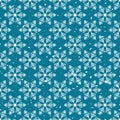 Winter wonderland delicate white snowflake crystals on a teal blue snow textured background Royalty Free Stock Photo