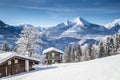 Winter wonderland scenery in the Alps with traditional mountain chalets Royalty Free Stock Photo