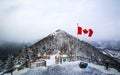 Winter Wonderland: Snow-Covered Mountain with Canadian Flag in Banff, Canada