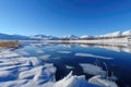winter wonderland, with snow-covered mountain peaks and frozen lakes, against a blue sky Royalty Free Stock Photo