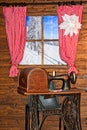 Winter. A wooden house. Window with red curtains