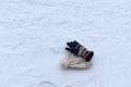 Winter woolen glove and cap lost in snow. Royalty Free Stock Photo