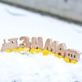 Winter word composed of Russian language wooden letters train cars on the white snow. holiday decorations. Royalty Free Stock Photo