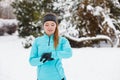 Winter workout. Girl wearing sportswear, looking at watch