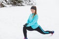 Winter workout. Girl wearing sportswear, stretching exercises Royalty Free Stock Photo