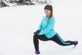 Winter workout. Girl wearing sportswear, stretching exercises. Royalty Free Stock Photo