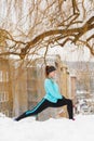 Winter workout. Girl wearing sportswear, stretching exercises. Royalty Free Stock Photo