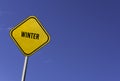 Winter - yellow sign with blue sky background