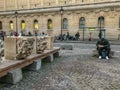 Man sits in newly designed Place du Pantheon and writes in a notebook in Paris, France