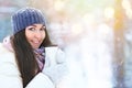 Winter young woman portrait. Beauty Joyful Model Girl holding thermocup with hot tea and smiling, having fun in winter Royalty Free Stock Photo