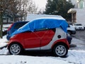Make shift winterized small red car in public parking lot Royalty Free Stock Photo