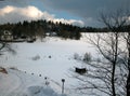 A winterlandscape with dark cloud, snow and small slope