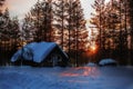 Winterly forest hut in Swedish lapland sunset