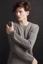 Winters chill - Fashion. A young man with elegant facial features wearing a woolen jersey and looking away thoughtfully. Royalty Free Stock Photo