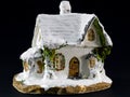 Winters christmas decoration with small toy ceramic house