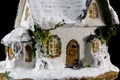 Winters christmas decoration with small toy ceramic house