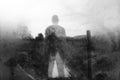 A winters day and a semi transparent male figure standing above a stream in the countryside. With a blurred, textured, weathered,