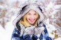 Wintertime. Closeup portrait of smiling winter girl in snowy park. Winter holidays and vacation. Beautiful woman in warm Royalty Free Stock Photo